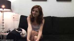 Redhead in a white tank top holds her pa - Picture 18