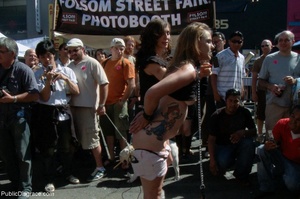 Blonde whore is led around a street fair - Picture 2
