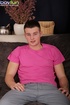 Skinny boy wearing pink shirt masturbates on the sofa and cums hard