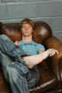 Cute teen boy takes off his clothes and masturbates on the couch