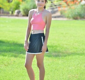 Smiling teen gal toying her pink twat in a close up