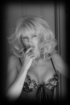 Lusty blonde in sheer lingerie moves her panties aside, so sneak a peek