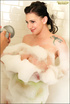 Brunette with dragonfly tattoo and big tits enjoys foamy hot bath