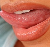 Sultry temptress likes to arch her back and lick her soft lips