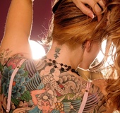 Beautiful tattooed damsel fingers her cunt in a shiny room