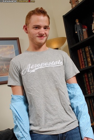 Handsome redhead takes off his gray shirt and jeans then shows his stud body before he pulls down his blue boxers and bares his big dick in different poses on a black couch. - XXXonXXX - Pic 2