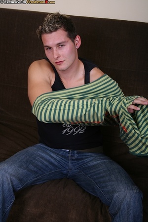 Handsome dude wearing black jacket, green and yellow striped shirt, black shirt, jeans and blue boxers strips them off piece by piece and expose his big dick and hunk body on a brown couch. - XXXonXXX - Pic 3