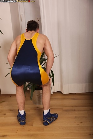 Gorgeous dude displays his hot body with hard muscles in blue and yellow spandex before he peels down his white supporter and jacks his cock wearing his blue and yellow rubber shoes. - Picture 2