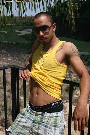 Hunk black dude peels off his yellow shirt and reveals his stud tattoooed body before he peels down his green and white checkered shorts and black boxers and reveals his giant cock. - Picture 3