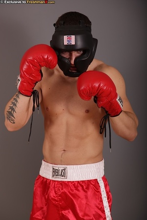 Gorgeous stud with big hard body takes off his black head gear, red and white shorts and black and white supporter then reveals his huge dick while he pose naked wearing his red boxing gloves. - Picture 1