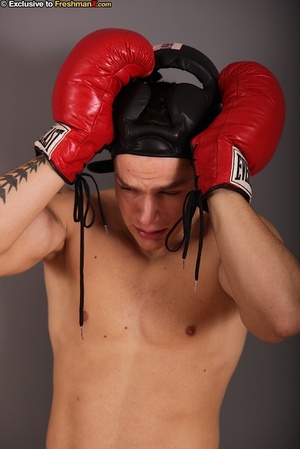 Gorgeous stud with big hard body takes off his black head gear, red and white shorts and black and white supporter then reveals his huge dick while he pose naked wearing his red boxing gloves. - Picture 2