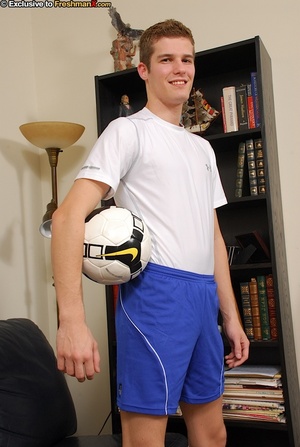 Handsome athlete wearing soccer uniform before he takes off his white shirt and blue shorts and reveals his stud body before he sits on a black couch and pulls his huge dick out of his white cycling shorts. - Picture 3