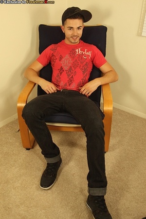 Gorgeous dude sits on a black chair then slowly strips off his red shirt and black pants and reveals his rock hard body while he jerks off wearing his black cap, shoes and red supporter. - Picture 1