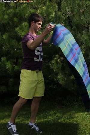 Sexy man peels off his purple shirt and displays his hard muscles before he pulls down his yellow shorts and reveals her long hard meat stick on a green and blue checkered blanket on a grass land. - XXXonXXX - Pic 3