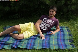 Sexy man peels off his purple shirt and displays his hard muscles before he pulls down his yellow shorts and reveals her long hard meat stick on a green and blue checkered blanket on a grass land. - XXXonXXX - Pic 4