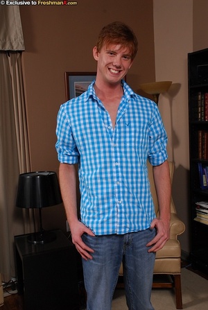 Gorgeous redhead takes off his blue and white checkered shirt and bares his stud body before he peels off his jeans and white brief and shows his long hard dick on a brown couch. - Picture 1