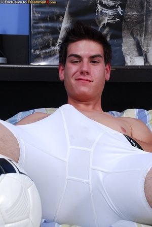 Gorgeous guy in soccer uniform peels off his blue shirt and displays his huge body as he lays down on a yellow, blue and white striped bed before he pulls down his red shorts and white underpants then lays down and jacks his cock. - XXXonXXX - Pic 6