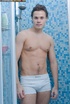 Handsome stud gets in a shower and pose his muscular body before he peels