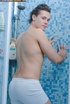 Handsome stud gets in a shower and pose his muscular body before he peels