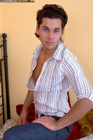 Handsome gay dude pose on a multi-colored floral bed before he strips off his gray and white striped shirt and reveals his stud body before he peels down his blue jeans then wanks his dick hard. - XXXonXXX - Pic 1