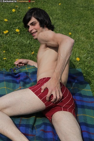 Gorgeous dude peels off his black and red striped shirt and teases with his rock hard body before he peels down his black jeans and maroon boxers then pumps his jizz out on a green and blue checkered blanket outdoor. - Picture 6
