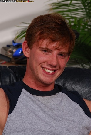 Redhead gay dislays his skinny body in black and blue spandex before he gets naked and reveals his large cock on a black couch. - XXXonXXX - Pic 2