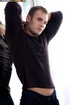 Handsome guy with stoney body peels off his black shirt then pulls his
