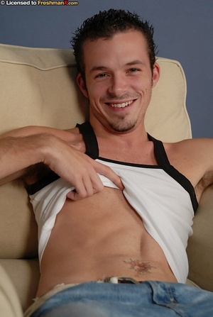Cute dude shows his tight abs before he slowly peels off his white shirt, jeans and yellow and gray brief and expose his big dick as he lays naked on a brown couch. - Picture 2