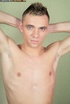 Sweet dude with spikey hair wearing gray shirt and jeans takes them off