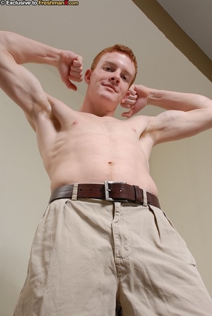 Redhead hottie shows his thin muscular body as he strips off his blue and black shirt and gray shorts before he peels down his black boxers and strokes his large dick on a wooden stool. - XXXonXXX - Pic 4