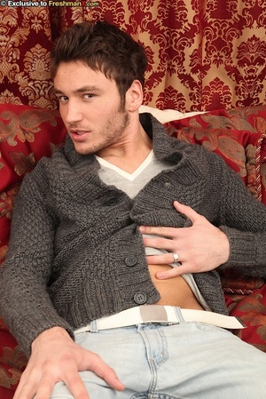 Handsome gay strips off his gray sweater, shirt and blue jeans then shows his hot abs and rock hard body before he pulls his dick out of his purple brief and wanks it on a maroon and gold couch - XXXonXXX - Pic 2