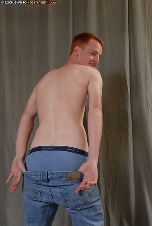 Young dude wearing brown shirt, black jacket, blue jeans, boxers and brown shoes slowly peel off his clothes and expose his skinny body and big dick as he sits naked on a brown stool. - Picture 5