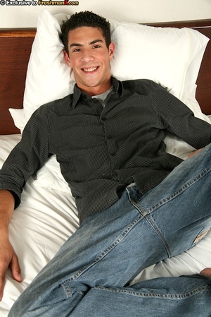 Sweet dude lays down on a white bed and slowly strips off his black polo, gray shirt, jeans and black brief then displays his hunk body and big dick. - Picture 1