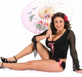Latin bitch with sexy smile and big boobs sits wearing hot black lingerie