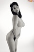 This naked beauty acts shy in front of the camera but loves her huge tits