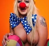 Long haired blonde in a colorful clown suit gets very naughty