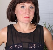 Shy matue MILF in black dress toys with her naked pussy.
