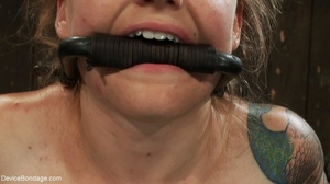 Gagged blonde is bound to BDSM equipment - Picture 16