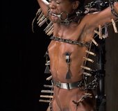 In a frightening dungeon, a blonde and an ebony are treated like the filthy
