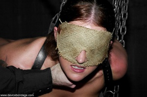 A burlap blindfold robs a slave of the ability to see while her body is put through forbidding slave training. - Picture 17