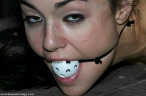 A small whiffle ball is used to gag a darling dark-haired submissive with a lost look in her eyes. - XXXonXXX - Pic 17