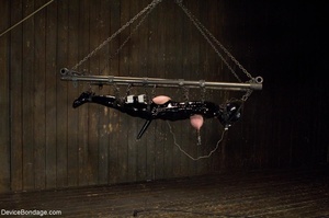Big-breasted bitch is placed in a series of bondage implements for her Domme’s pleasure. - Picture 5