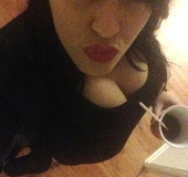 Dark haired cutie showing off her big balloons at home