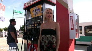 Gorgeous blonde wearing multi colored tube dress pulls down her black panty and reveals her indulging pussy on a gas station. - XXXonXXX - Pic 5