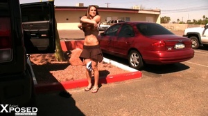 Alluring chick slowly strips off her blue shirt, brown skirt and white panty then expose her hot body with lusty boobs and sweet pussy as she pose naked in a parking lot. - XXXonXXX - Pic 1