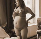 Two pregnant hotties touch each other's engorged tits and preggo bellies