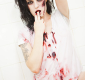 A zombie virus causes this hot brunette to pick at her own flesh
