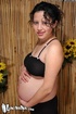 Beautiful pregnant woman undresses and reveals her huge belly and her