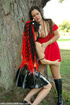 Erotic goths in red and black dresses have fun together outside