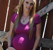 A purple top and white shorts can’t hide this pregnant blonde’s hot